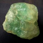 a rough cut green gem