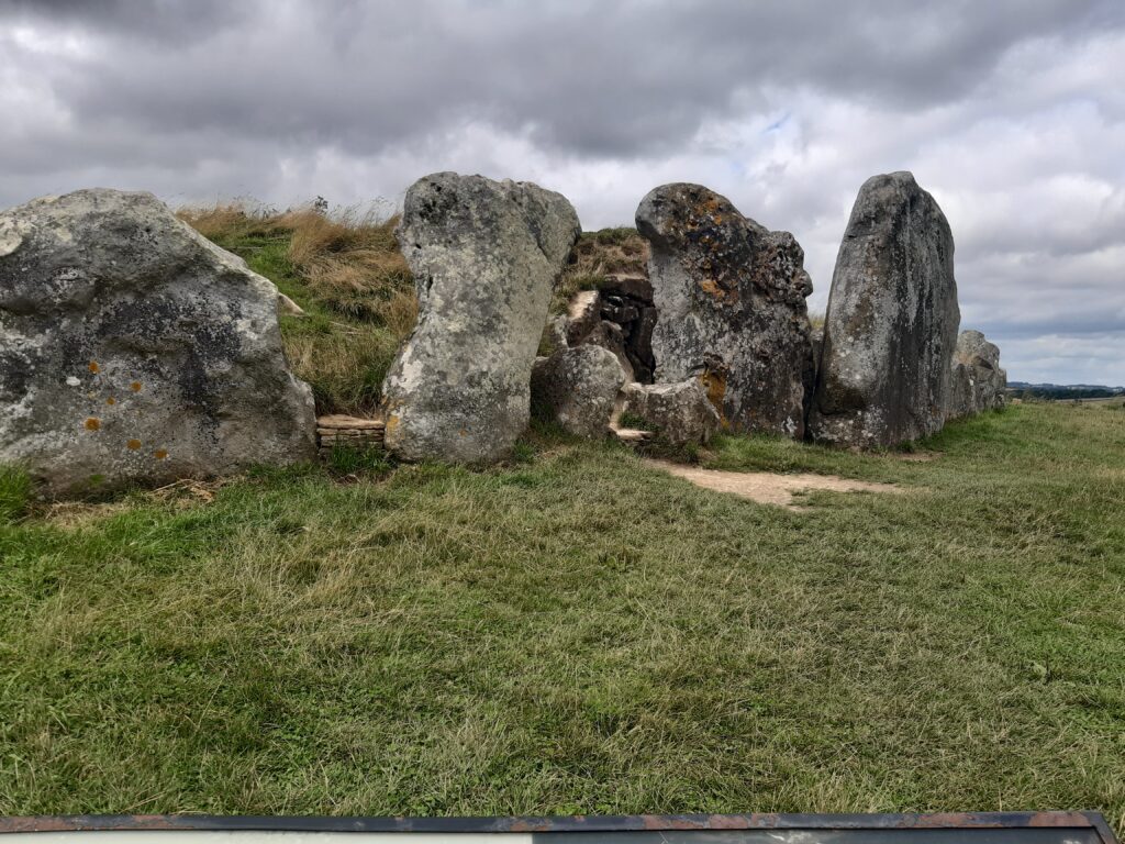 The rocks guarding the entrance of a long grassy mound that is the long barrow